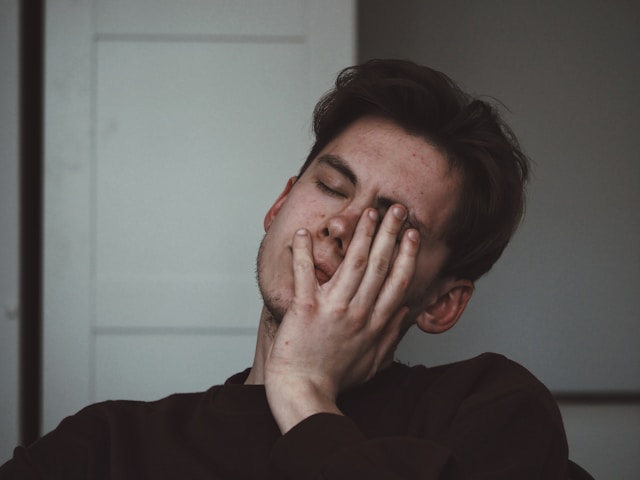man holding his head