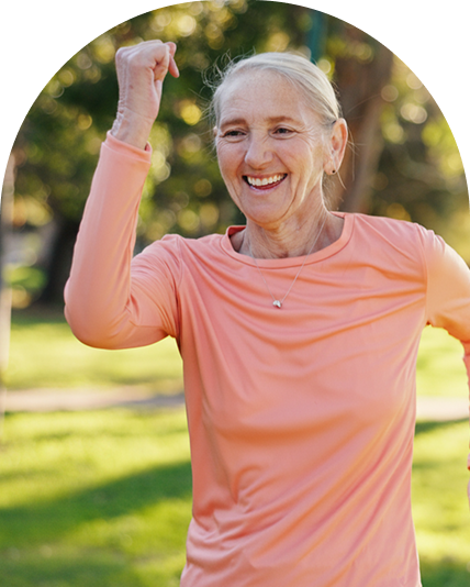 Older woman who is speed walking with a smile on her face.